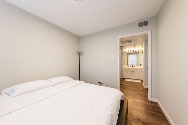 1212 Guadalupe St Unit 301, Austin, TX 78701 - bedroom featuring dark wood finished floors and baseboards