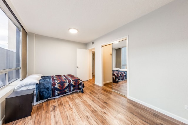 1212 Guadalupe St Unit 301, Austin, TX 78701 - bedroom with light wood-style flooring and a closet