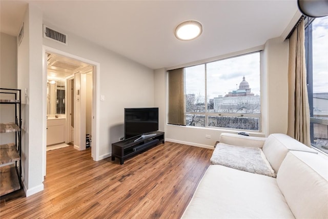1212 Guadalupe St Unit 301, Austin, TX 78701 - living room featuring wood finished floors and baseboards