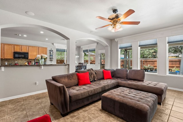 1600 Grand Falls Dr, Cedar Park, TX 78613 - living room with arched walkways, a ceiling fan, and light tile patterned floors