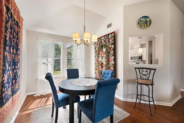 2004 Yaupon Trl, Cedar Park, TX 78613 - dining room with a chandelier, wood finished floors, and vaulted ceiling