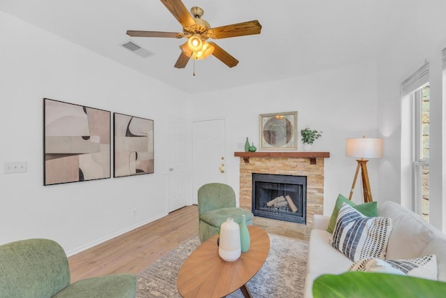 2414 Longview St Unit 101, Austin, TX 78705 - living area featuring ceiling fan, a stone fireplace, and wood finished floors