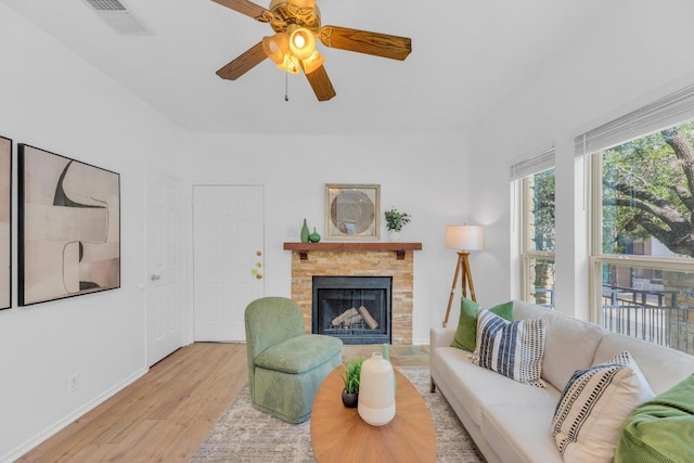2414 Longview St Unit 101, Austin, TX 78705 - living room featuring wood finished floors, a fireplace with raised hearth, and ceiling fan