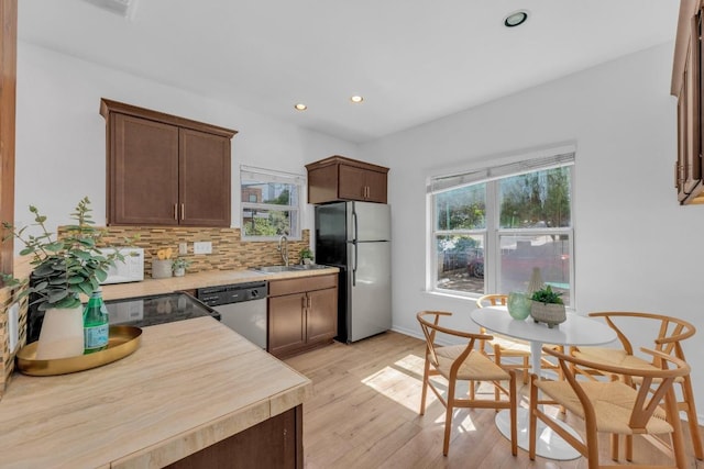 2414 Longview St Unit 101, Austin, TX 78705 - kitchen featuring appliances with stainless steel finishes, light countertops, tasteful backsplash, recessed lighting, and light wood finished floors