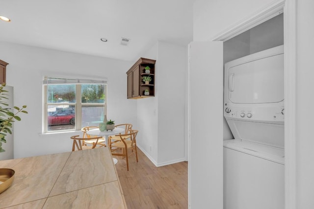 2414 Longview St Unit 101, Austin, TX 78705 - laundry room featuring estacked washer and dryer, light wood-type flooring, and recessed lighting