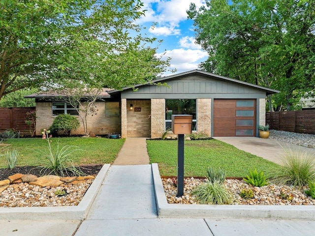 1214 Arthur Stiles Rd, Austin, TX 78721 - view of front of house featuring concrete driveway, an attached garage, board and batten siding, and brick siding