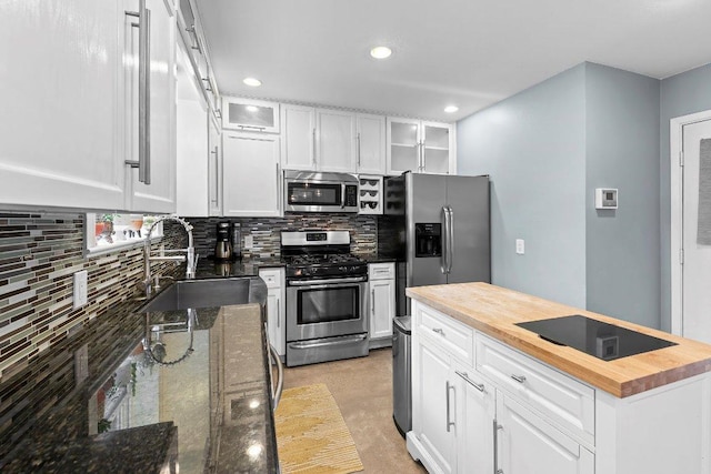 1214 Arthur Stiles Rd, Austin, TX 78721 - kitchen featuring stainless steel appliances, wooden counters, white cabinets, tasteful backsplash, and recessed lighting