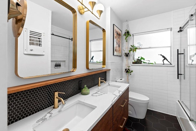 1214 Arthur Stiles Rd, Austin, TX 78721 - full bathroom with tile walls, double vanity, tile patterned flooring, and  shower combination