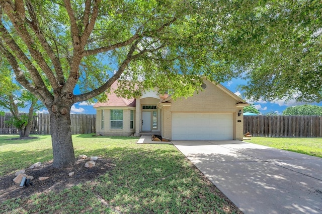 131 Martin Crossing Dr, Cedar Creek, TX 78612 - view of front of home with an attached garage, driveway, and brick siding
