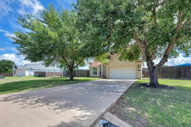 131 Martin Crossing Dr, Cedar Creek, TX 78612 - view of property hidden behind natural elements featuring a garage and concrete driveway