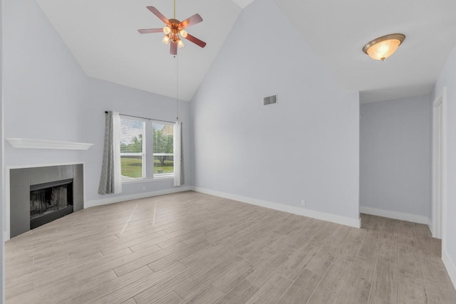131 Martin Crossing Dr, Cedar Creek, TX 78612 - unfurnished living room with a ceiling fan, light wood-style floors, high vaulted ceiling, and a fireplace