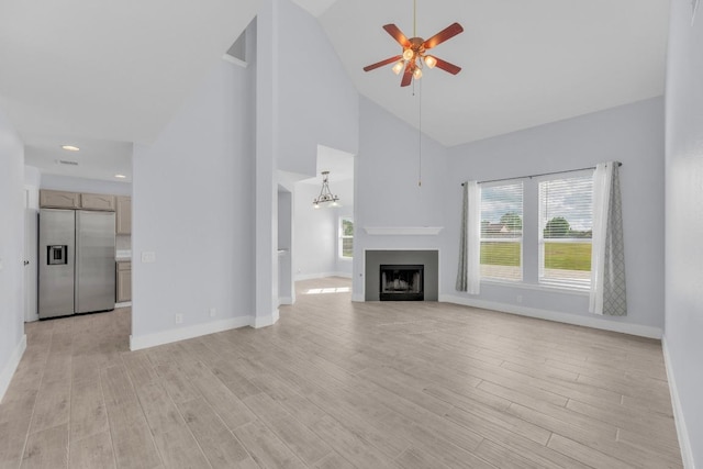 131 Martin Crossing Dr, Cedar Creek, TX 78612 - unfurnished living room featuring ceiling fan, high vaulted ceiling, light wood-style floors, and a fireplace