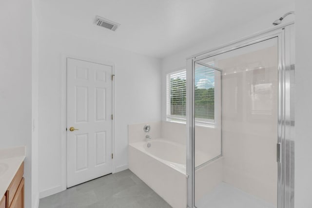 131 Martin Crossing Dr, Cedar Creek, TX 78612 - full bathroom with vanity, a bath, a shower stall, and tile patterned flooring