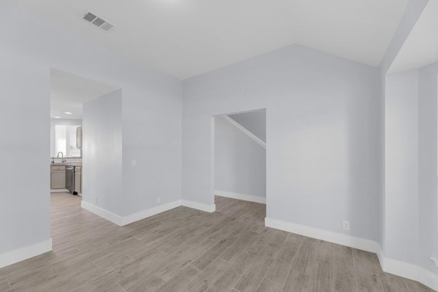 131 Martin Crossing Dr, Cedar Creek, TX 78612 - unfurnished living room featuring light wood-type flooring and vaulted ceiling