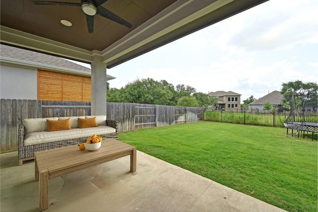 149 Beryl Way, Dripping Springs, TX 78620 - fenced backyard with a trampoline, a patio area, a ceiling fan, and an outdoor living space