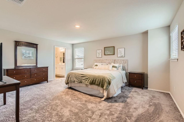 501 Goat Willow Ln, Georgetown, TX 78626 - bedroom with multiple windows, carpet flooring, and connected bathroom