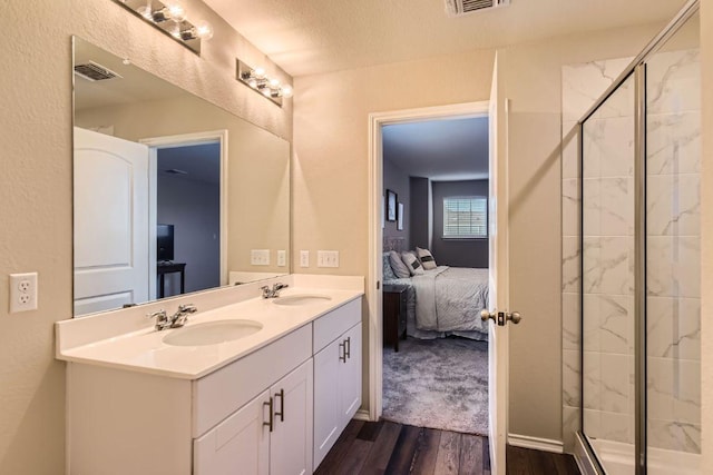 501 Goat Willow Ln, Georgetown, TX 78626 - bathroom featuring ensuite bath, wood finished floors, double vanity, and a shower stall
