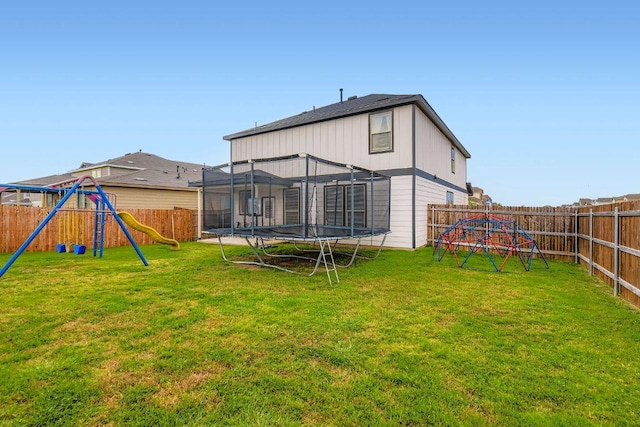 501 Goat Willow Ln, Georgetown, TX 78626 - back of house featuring a trampoline, a playground, and a fenced backyard