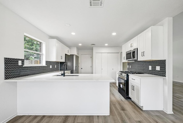 1105 Madrone Trl, Leander, TX 78641 - kitchen with appliances with stainless steel finishes, decorative backsplash, light countertops, recessed lighting, and white cabinets