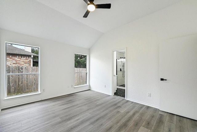 1105 Madrone Trl, Leander, TX 78641 - unfurnished bedroom with wood finished floors, lofted ceiling, ensuite bath, and a ceiling fan