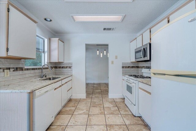 1705 Timberwood Dr, Cedar Park, TX 78613 - kitchen with white appliances, decorative backsplash, crown molding, a textured ceiling, and white cabinetry