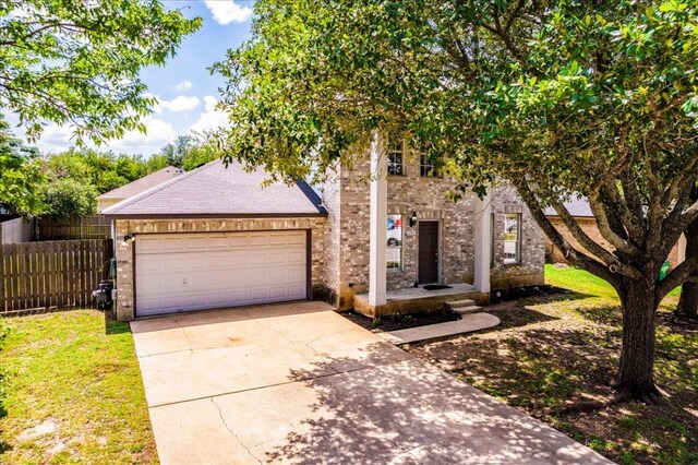 1705 Timberwood Dr, Cedar Park, TX 78613 - view of front facade with concrete driveway, a garage, brick siding, and roof with shingles