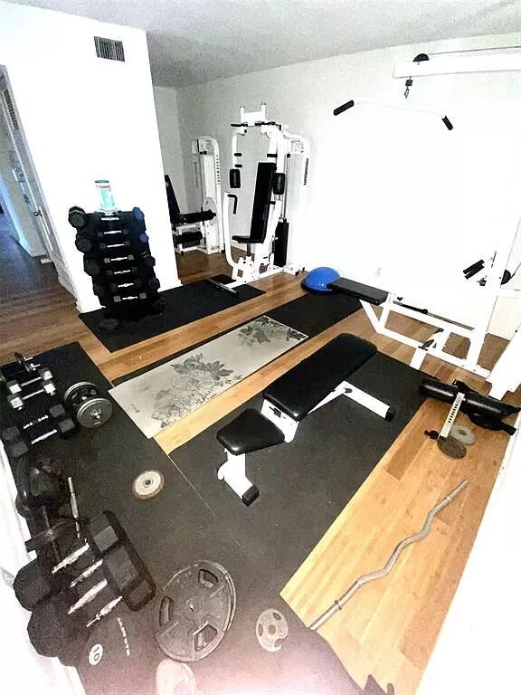 2303 Eastside Dr # 209, Austin, TX 78704 - exercise room featuring wood finished floors
