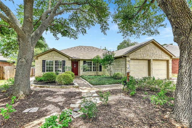 5509 Kayview Dr, Austin, TX 78749 - ranch-style home featuring stone siding, a garage, and a shingled roof
