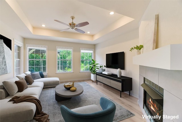 5509 Kayview Dr, Austin, TX 78749 - living area featuring a tiled fireplace, healthy amount of natural light, light wood-style floors, a ceiling fan, and recessed lighting