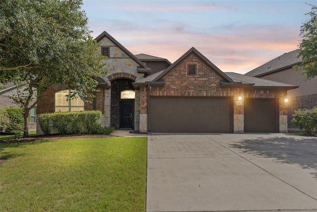 17900 Crimson Apple Way, Pflugerville, TX 78660 - french country inspired facade with a garage, stone siding, driveway, a front yard, and brick siding