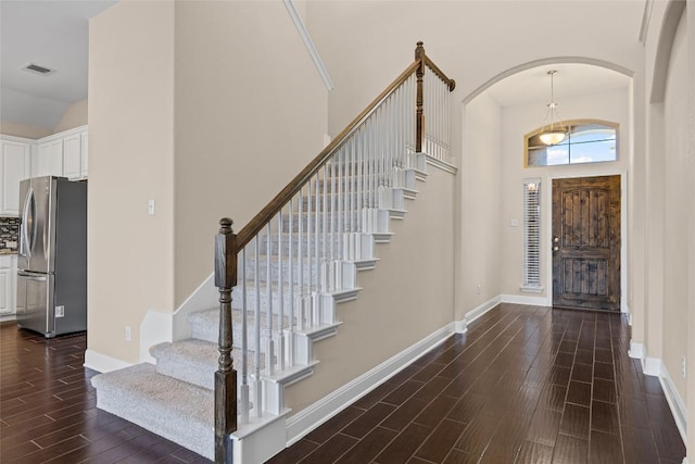 17900 Crimson Apple Way, Pflugerville, TX 78660 - foyer with wood tiled floors, stairway, a towering ceiling, and arched walkways