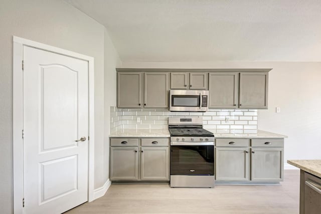 4408 Tello Path, Austin, TX 78749 - kitchen featuring appliances with stainless steel finishes, gray cabinetry, and backsplash