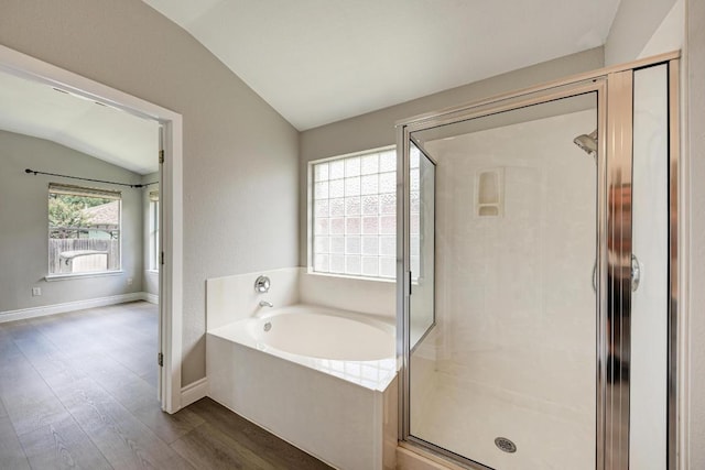 4408 Tello Path, Austin, TX 78749 - bathroom featuring vaulted ceiling, a bath, wood finished floors, and a shower stall