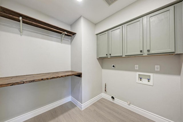 4408 Tello Path, Austin, TX 78749 - laundry area with hookup for an electric dryer, light wood finished floors, washer hookup, cabinet space, and hookup for a gas dryer