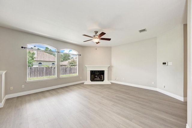4408 Tello Path, Austin, TX 78749 - unfurnished living room featuring a ceiling fan, wood finished floors, and a fireplace with raised hearth