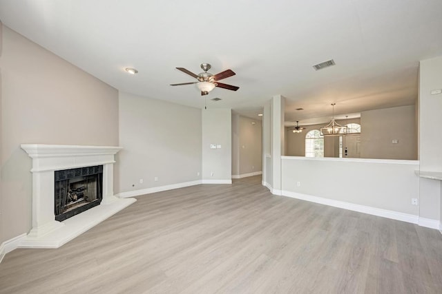 4408 Tello Path, Austin, TX 78749 - unfurnished living room with ceiling fan, wood finished floors, a fireplace, and a chandelier
