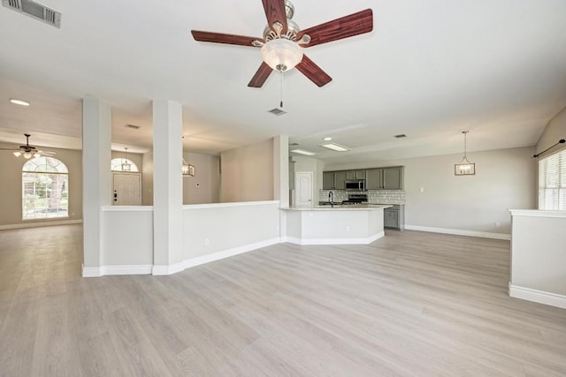 4408 Tello Path, Austin, TX 78749 - unfurnished living room with ceiling fan, plenty of natural light, and light wood-style floors