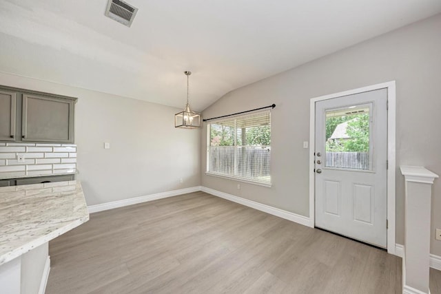 4408 Tello Path, Austin, TX 78749 - unfurnished dining area featuring light wood-style flooring, lofted ceiling, and a chandelier