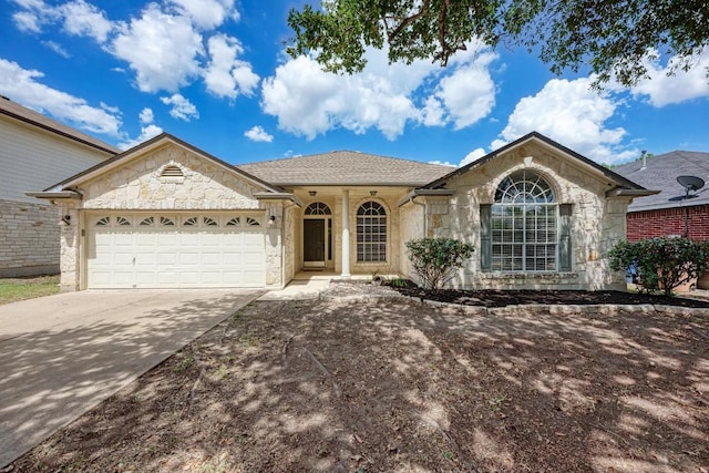 4408 Tello Path, Austin, TX 78749 - view of front facade featuring stone siding, concrete driveway, and a garage