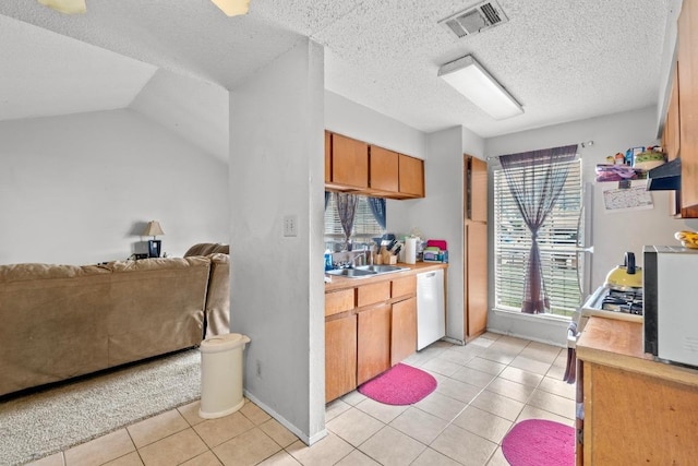 10706 Topperwein Dr, Austin, TX 78758 - kitchen featuring white appliances, open floor plan, light tile patterned flooring, light countertops, and a textured ceiling