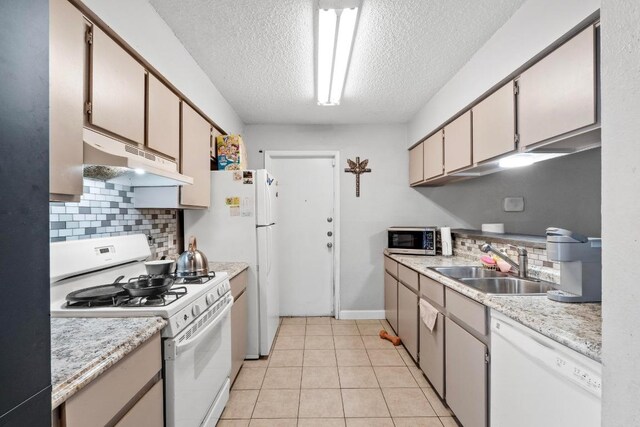 10706 Topperwein Dr, Austin, TX 78758 - kitchen featuring white appliances, under cabinet range hood, a textured ceiling, decorative backsplash, and light countertops