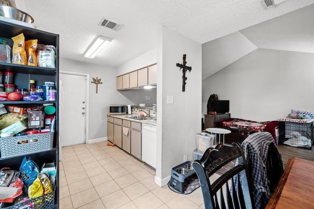 10706 Topperwein Dr, Austin, TX 78758 - kitchen with stainless steel microwave, light countertops, white dishwasher, light tile patterned floors, and a textured ceiling