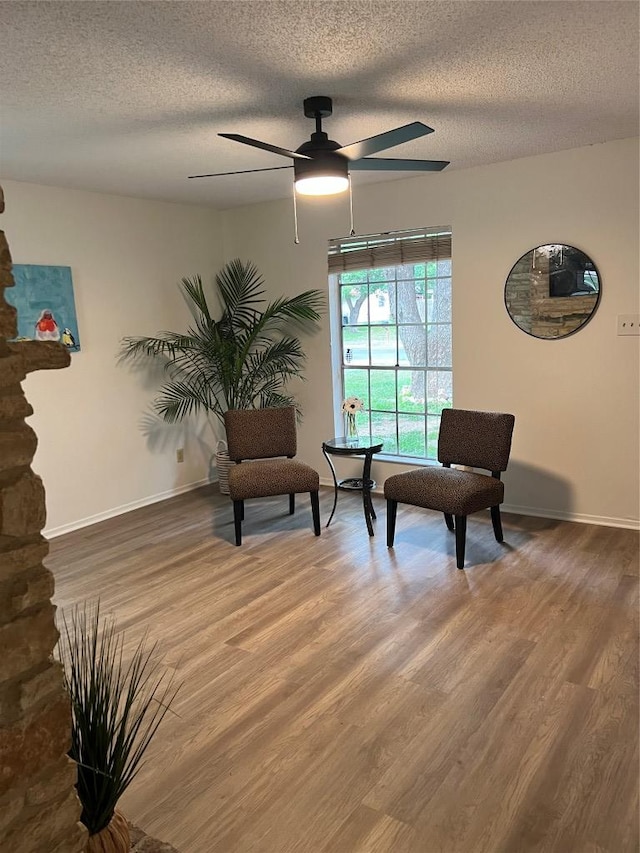 6506 Clubway Ln, Austin, TX 78745 - living area featuring wood finished floors, a ceiling fan, and a textured ceiling