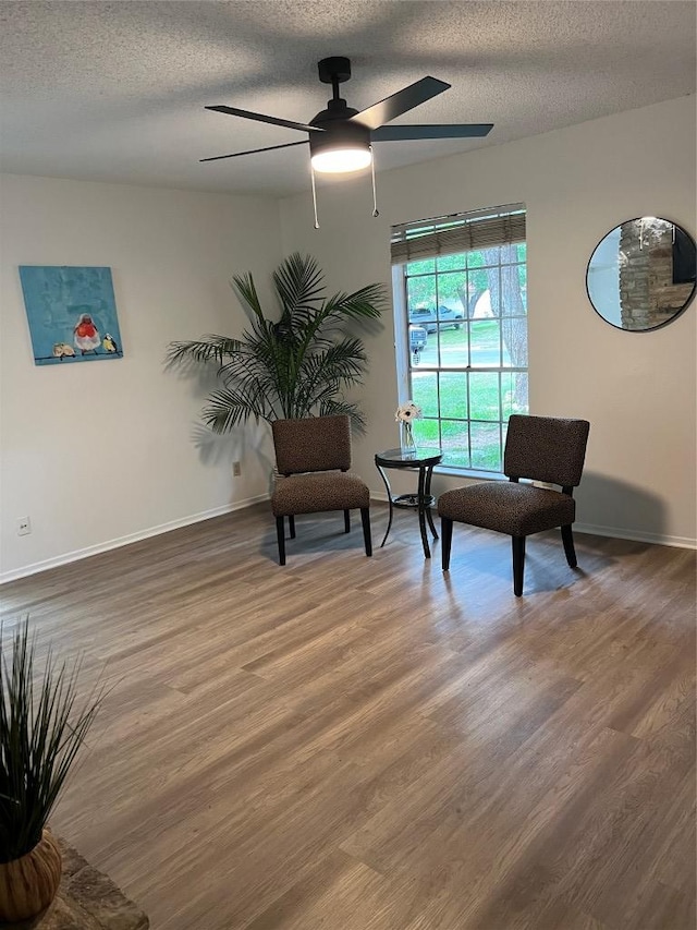 6506 Clubway Ln, Austin, TX 78745 - living area featuring wood finished floors, ceiling fan, and a textured ceiling