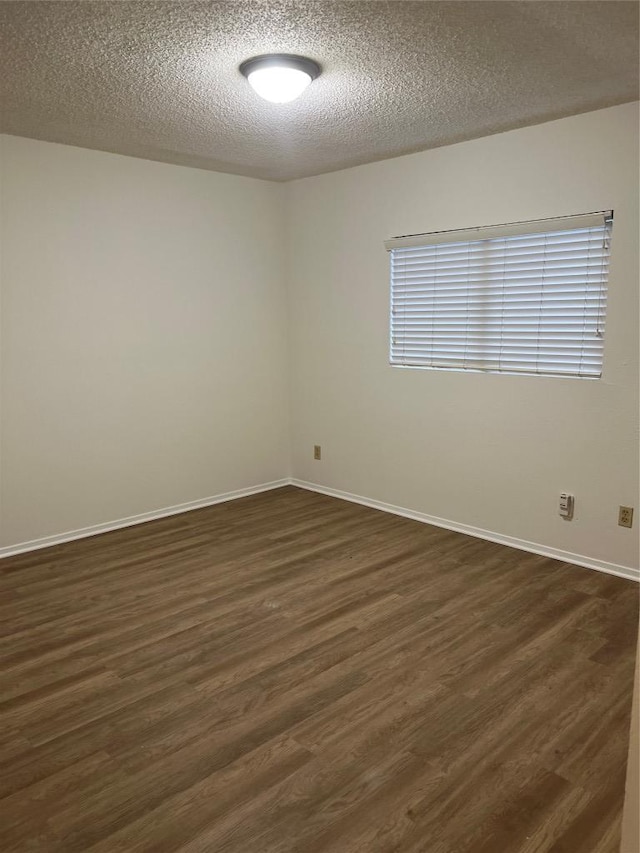 6506 Clubway Ln, Austin, TX 78745 - empty room with dark wood-type flooring and a textured ceiling