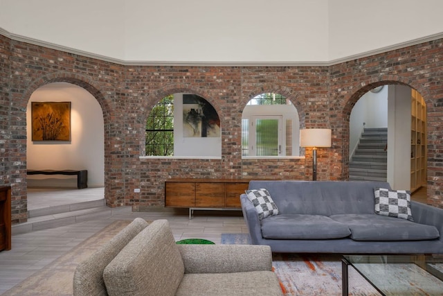 5301 Backtrail Dr, Austin, TX 78731 - living area featuring wood finished floors, brick wall, and stairs