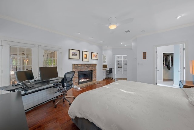 5301 Backtrail Dr, Austin, TX 78731 - bedroom with crown molding, hardwood / wood-style floors, a desk, a fireplace, and french doors