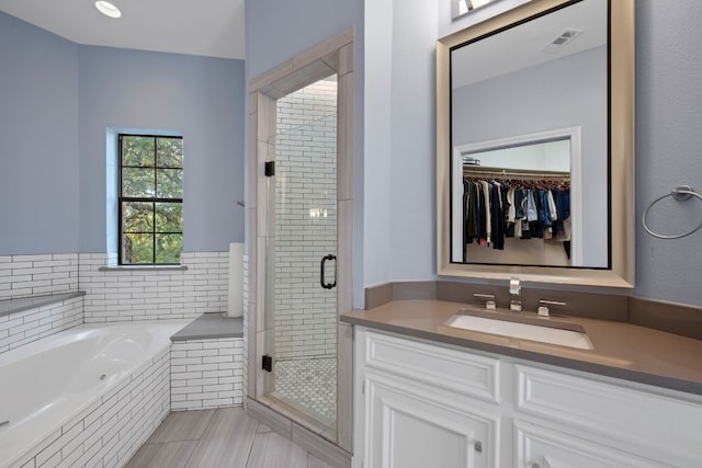 5301 Backtrail Dr, Austin, TX 78731 - full bath with a stall shower, a bath, vanity, and a walk in closet