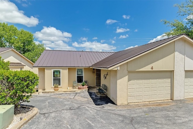 200 Full Moon Unit 4, Horseshoe Bay, TX 78657 - single story home with stucco siding, a metal roof, and an attached garage
