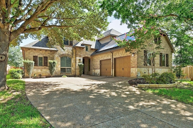 3340 Marcasite Dr, Round Rock, TX 78681 - view of front of property featuring stone siding, an attached garage, and concrete driveway